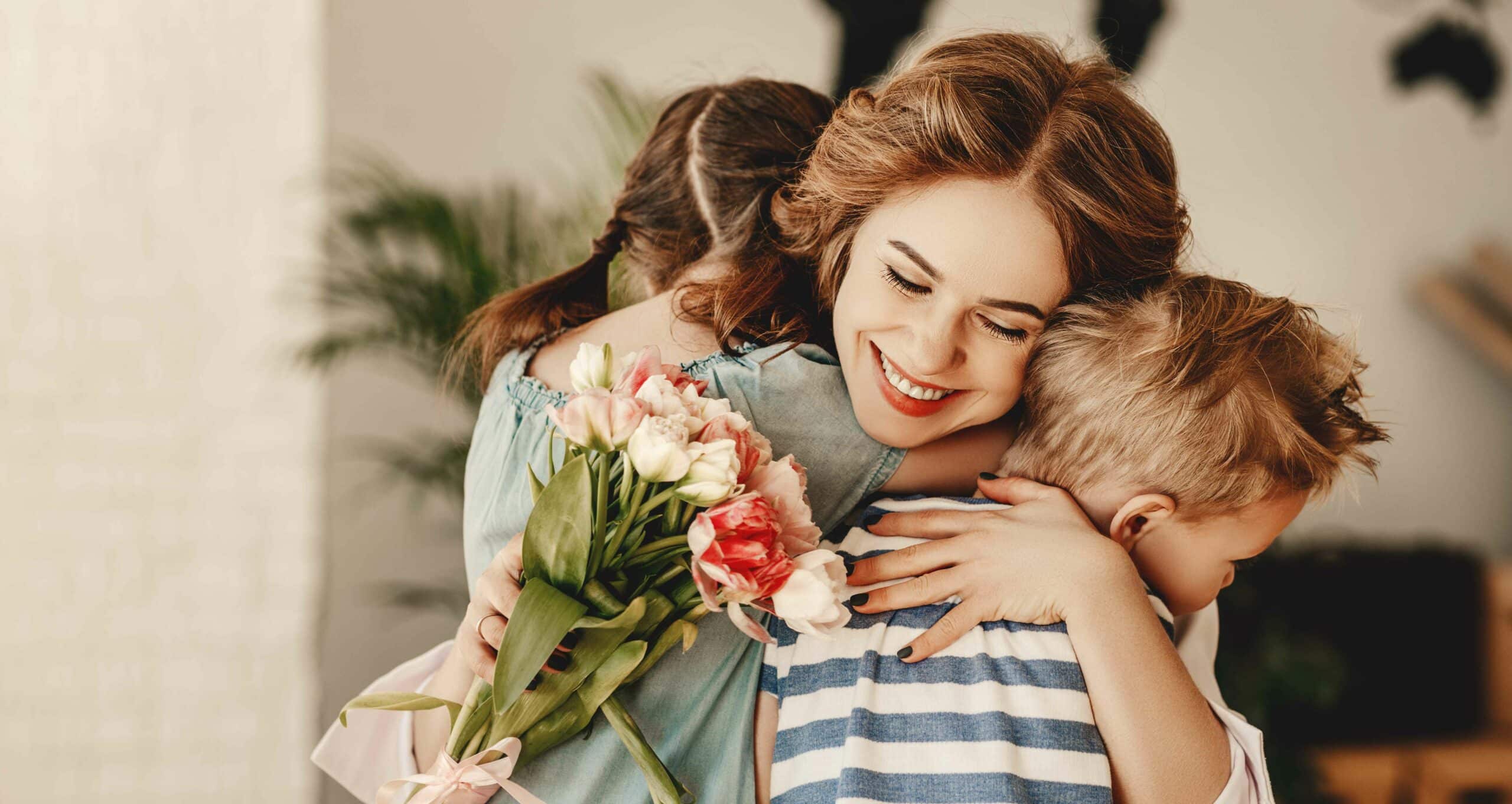 A mother embracing her two children on Mother's Day